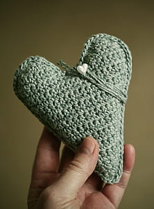 person holding gray heart knit decor thumbnail