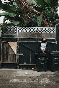 man sitting on garbage bin thumbnail