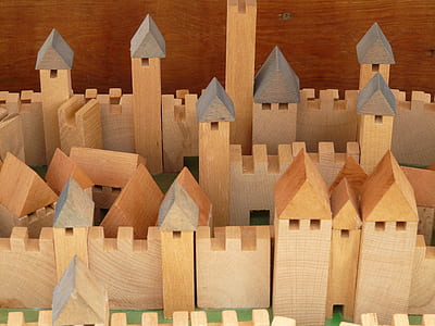 beige wooden castle miniature on brown surface thumbnail