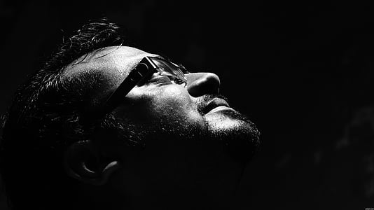 grayscale photo of man wearing eyeglasses looking up thumbnail
