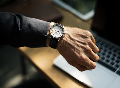 person wearing black and white analog watch thumbnail