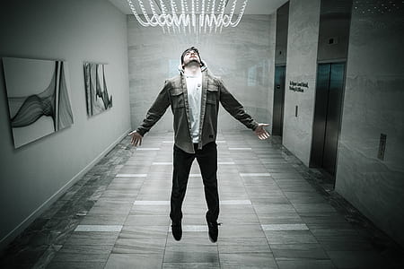 man levitating in hallway lobby with elevator thumbnail