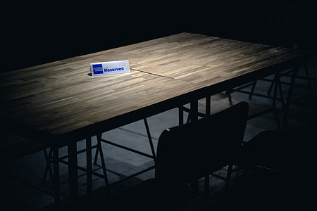 brown wooden table with reserved signage thumbnail