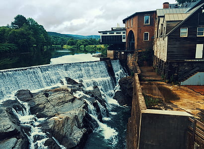 flowing water near buildings and green trees at daytime thumbnail