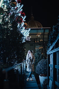 woman looking at lit trees thumbnail