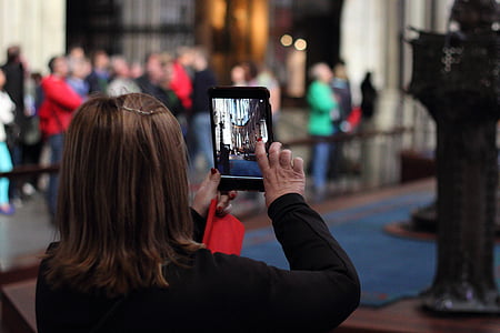 woman holding iPad taking picture thumbnail