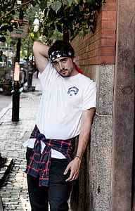 man taking photo while leaning on wall thumbnail