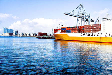 yellow and white cargo ship on body of water during daytime thumbnail
