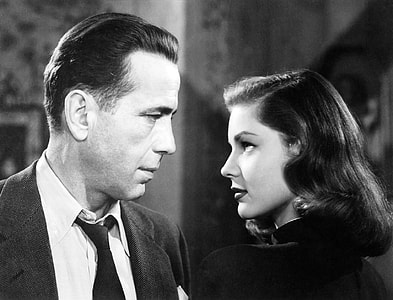 black and white photography of man wearing black suit facing woman with black dress thumbnail