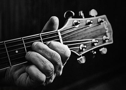 grayscale photo of person holding guitar thumbnail