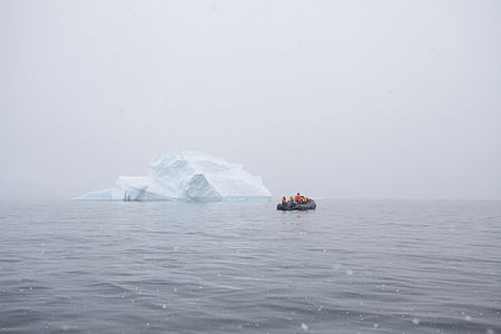 people on boat near iceberg at daytime thumbnail
