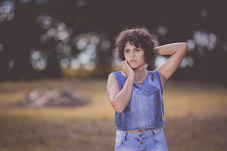 Woman Standing on Field Selective Focus Photography thumbnail