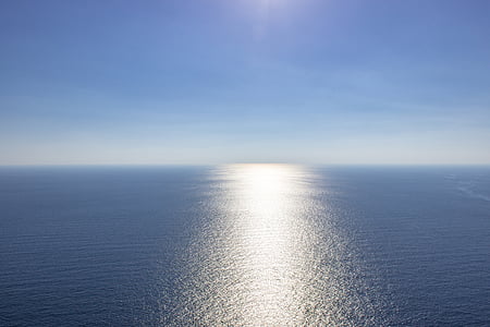landscape photography of ocean under clear sky during daytime thumbnail
