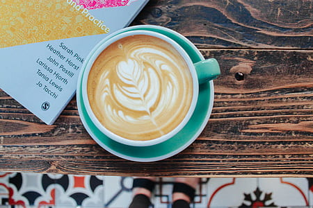 coffee in teal ceramic cup on table thumbnail