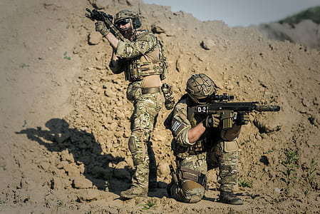 Two Men in Army Uniforms With Guns thumbnail