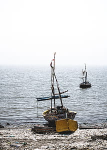 brown boat docked on seashore thumbnail