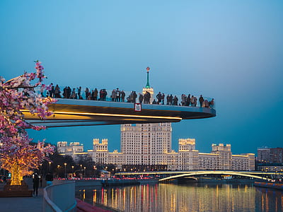 people standing on platform above the river thumbnail