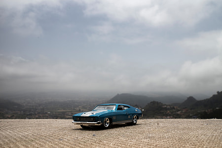 blue muscle coupe with white racing stripes thumbnail