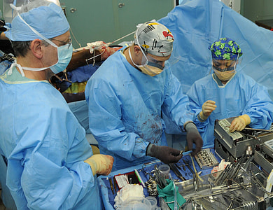 three person standing inside operating room thumbnail