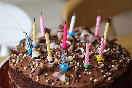 chocolate cake with eleven assorted-color birthday candles thumbnail