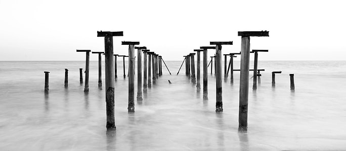 photo of gray metal post at body of water during daytime thumbnail