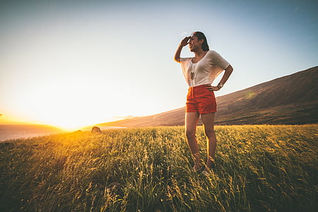 woman standing on green grass field thumbnail