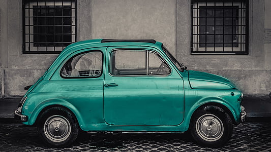 green 3-door hatchback parked on roadside thumbnail