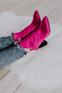 A woman in pink boots and blue jeans thumbnail