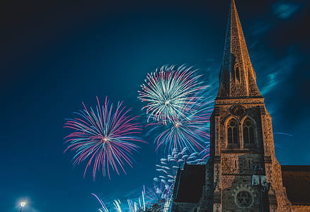 fireworks display over brown cathedral thumbnail