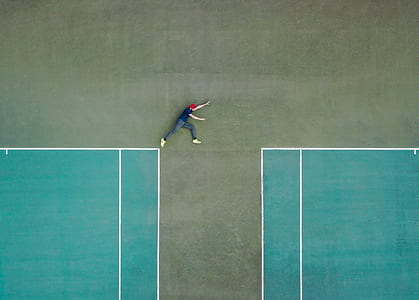 high angel photography of man lying in the court thumbnail