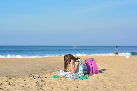 woman behind pink backpack near seashore thumbnail