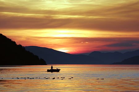 boat on the body of water during sunset thumbnail