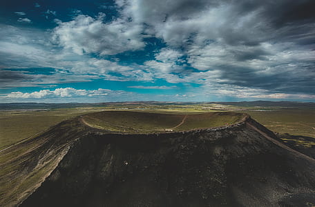 areal photography of mountain under blue sky thumbnail