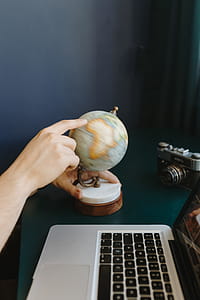Male Finger Showing A Part Of The World On An Globe thumbnail