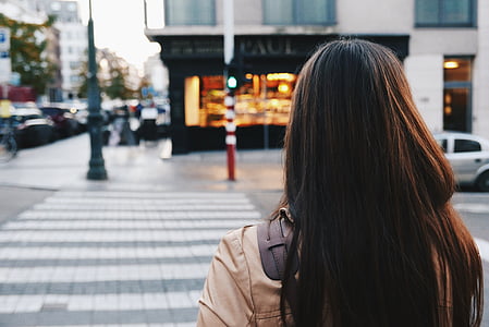 selective focus photography of woman walking on pedestrian lane thumbnail