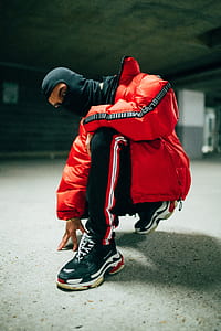 man kneeling on floor while looking at the camera thumbnail