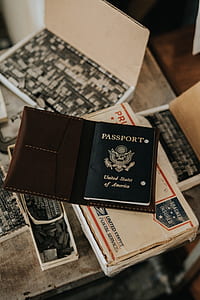 passport on top of white cardboard box thumbnail