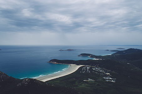 aerial photography of island under gray cloudy sky at daytime thumbnail