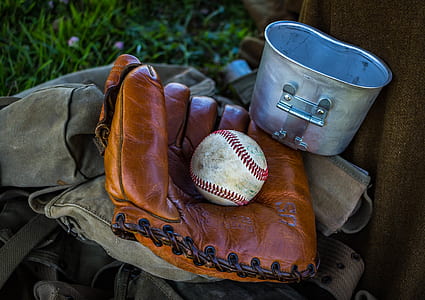 brown leather baseball mitt and white baseball thumbnail