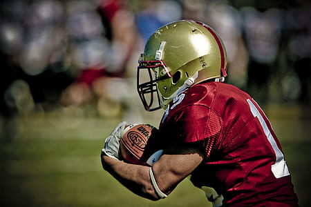 football player holding ball thumbnail