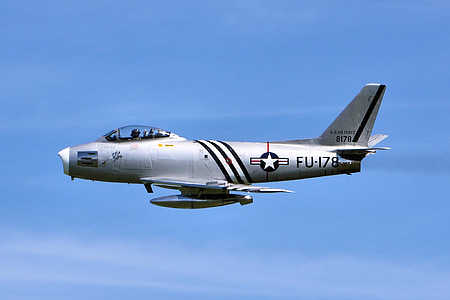 gray and black jet plane under blue skies during daytime thumbnail