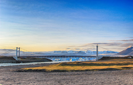 landscape photography of gray metal cable-stay bridge under blue sky during daytime thumbnail