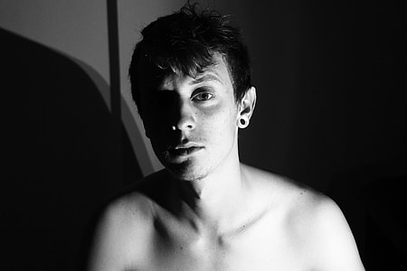 grayscale photo of topless man thumbnail
