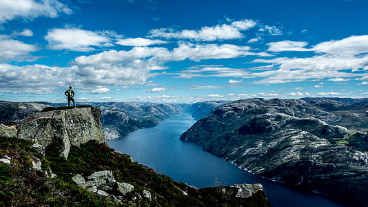 photo of body of water between cliff thumbnail