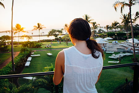 woman standing near handrail facing body of water thumbnail