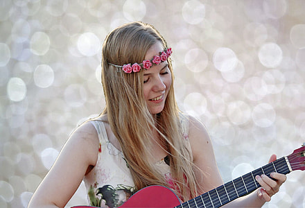 woman in beige and black sleeveless playing red acoustic guitar during daytime thumbnail