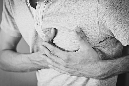 Man Wearing Polo Shirt Holding Left Chest thumbnail