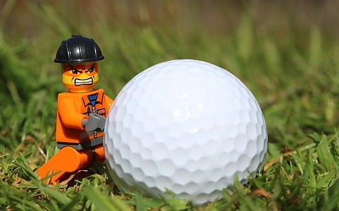 orange LEGO character minifig near golf ball thumbnail