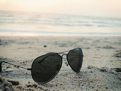 black aviator sunglasses on gray sand thumbnail