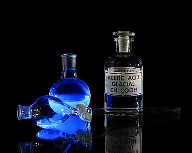 Chemical solutions glowing uner a black light. thumbnail